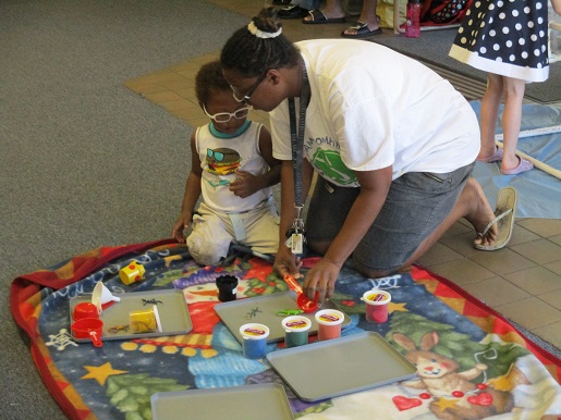 A mother and her child playing with clay at Make it Take it